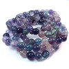 Bracciale in fluorite, una pietra naturale. Perline da 7 a 8 mm. Colori principali: viola, blu e verde.